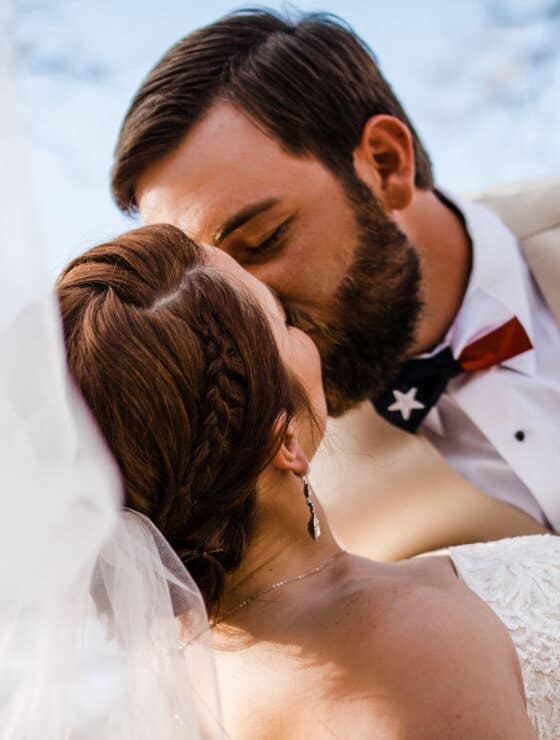 Close up view of bride and groom kissing